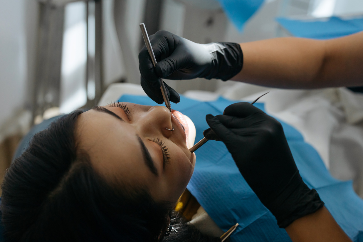 Close-up Photo of Dentist Examining Patient's Teeth 